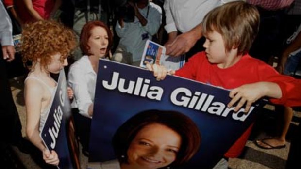Julia Gillard signed election posters for Mia and Jimmy Weeda at the Rapid Creek Business Village in Darwin.