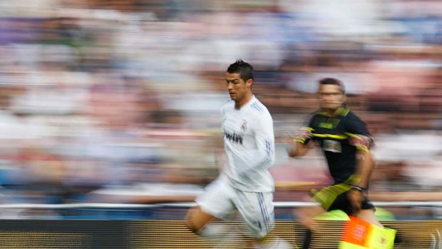 White-hot ... Cristiano Ronaldo is a blur of movement during Real Madrid's 8-1 win over Almeria, during which he scored twice to take his season tally to 40 -- a new La Liga record.