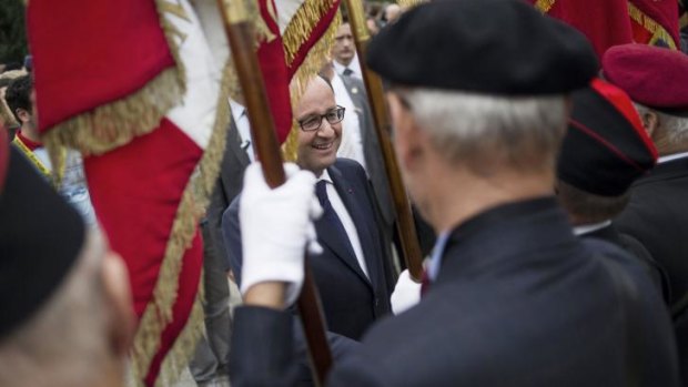 French President Francois Hollande shakes hands with veterans during a wreath-laying ceremony at the WWI Hartmannswillerkopf National Monument in north-eastern France.