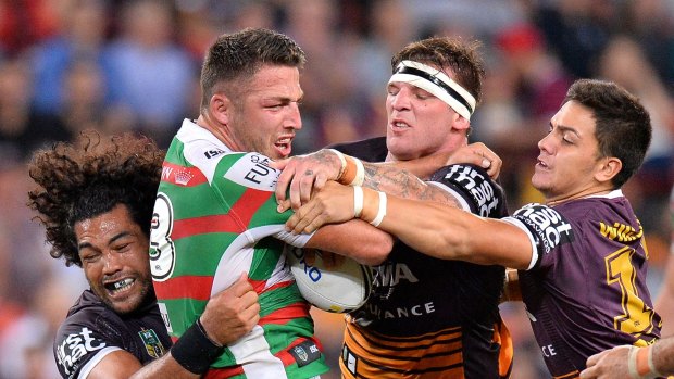 Roped in by the Broncos: Sam Burgess is tackled at Suncorp Stadium.