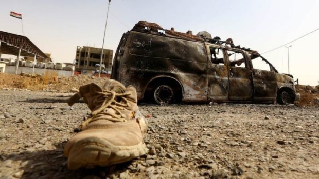 A burnt vehicle belonging to Iraqi security forces at a checkpoint in east Mosul.