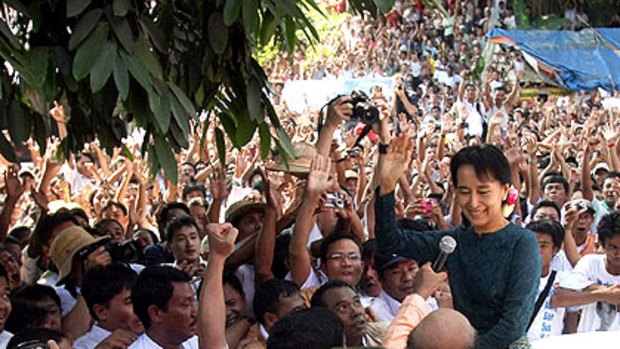 Burma's pro-democracy leader Aung San Suu Kyi is met at her party's headquarters by thousands of jubilant supporters defying a law banning gatherings of more than five people.