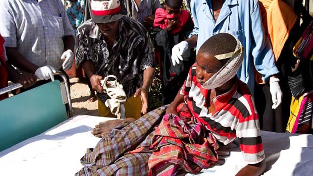 Aftermath ... a boy injured in the attack on Kipao is taken to hospital.