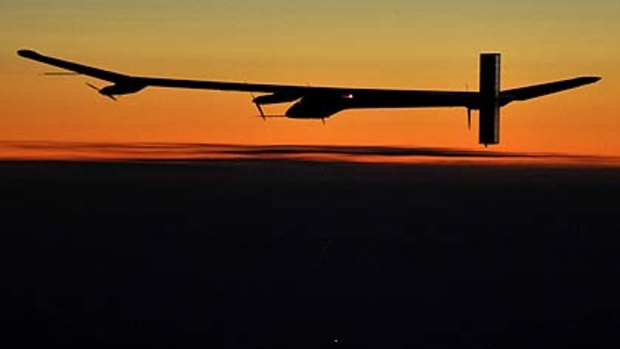 Solar Impulse's  pilot Andre Borschberg flies during sunset in the solar-powered HB-SIA prototype airplane during its first night flight attempt near Payerne airport.