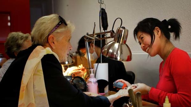 "It is so lovely to work for such nice ladies" ... Thuy Dienh attends to the nails of a client at Mosman.