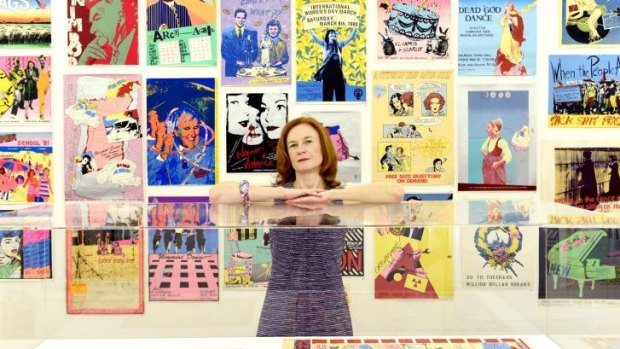 Curator Katie Yuill poses with the <i>Girls in the Tin Shed</i> exhibition at Sydney University Gallery.  