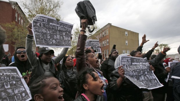 'No justice, no peace!' ...Marchers chant near the Baltimore police department's Western District police station during a march for Freddie Gray.