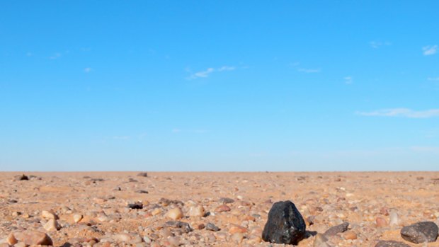 This NASA photo shows a black chunk of rock found in the Sudan desert, the first time astronomers have tracked an asteroid from space, through the Earth's atmosphere and down on the ground as a meteorite.