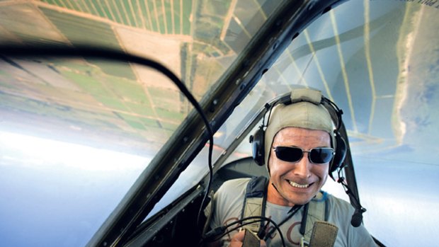 Peter Munro hangs on for dear life, upside down in a military plane.
