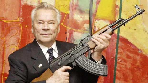 Weapon of mass destruction: Mikhail Kalashnikov presents his legendary assault rifle at the opening the exhibition in Germany earlier this year.