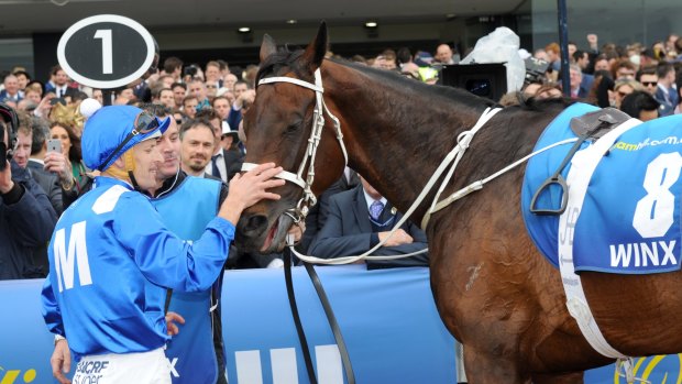 She's back: Hugh Bowman gives Winx a pat after her second Cox Plate victory.