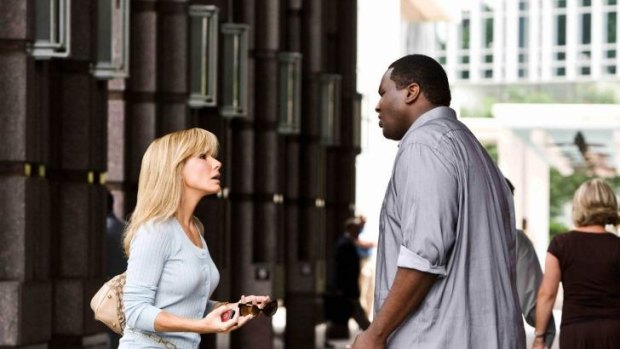 Sandra Bullock and Quinton Aaron as troubled footballer Michael Oher in 2009 film <i>The Blind Side</i>.