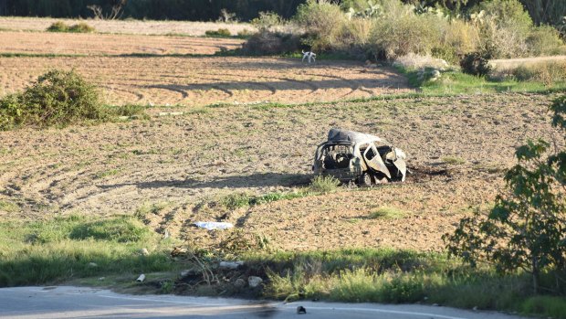 Car of Daphne Caruana Galizia lies next to a road after the explosion.