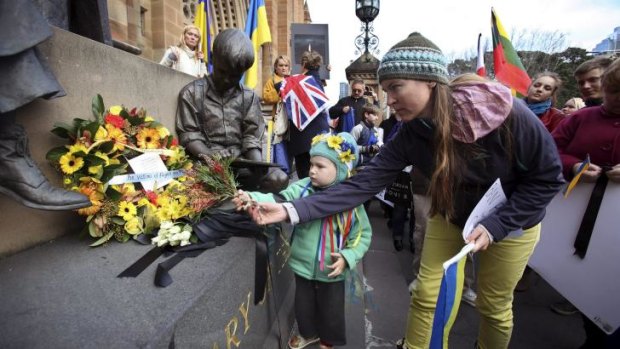 Ukrainian Community placing a reef of flowers and black ribbons at the Mary MacKillop Memorial, St Mary Cathedral in Sydney In memory of the passengers and crew that died on the Malaysian MH17 flight