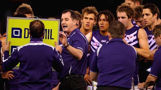 Ross Lyon speaks to his players during the round 22 match against North Melbourne.