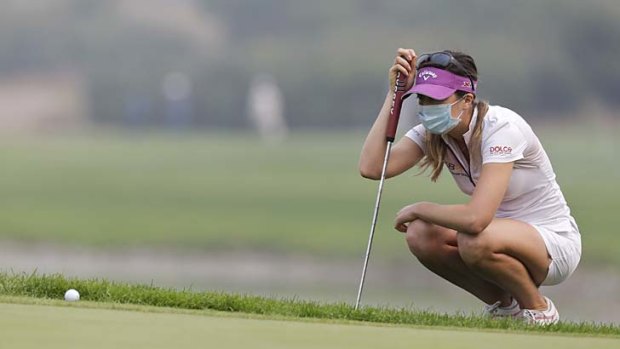 Hazy day: Germany's Sandra Gal wears a mask during the final round of the Reignwood LPGA Classic Golf Tournament at the Pine Valley Golf Club on the outskirts of Beijing.