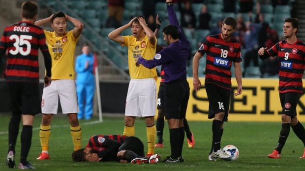 Disbelief: Guangzhou Evergrande react to one of the red cards.