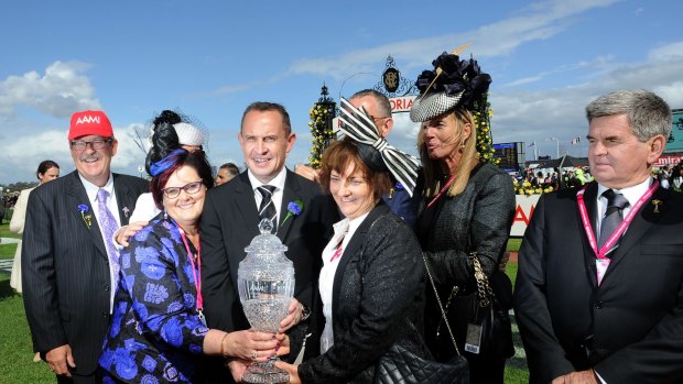 Genius: Chris Waller poses with connections after Preferment's Victoria Derby win.