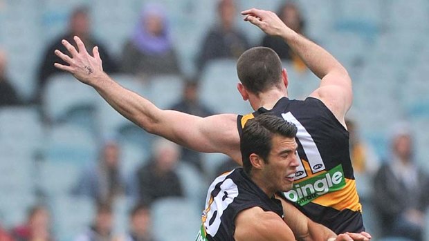 Docker destroyer: Two Richmond defenders are left floundering as Matthew Pavlich claims another mark.