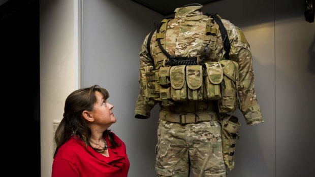 Larger than life... Head textiles conservator, Sarah Clayton inspects the combat uniform of Victoria Cross recipient Ben Roberts-Smith.