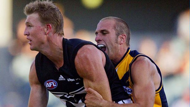 Respected rivals: Collingwood's Nathan Buckley is grabbed by Chris Judd the Eagle.