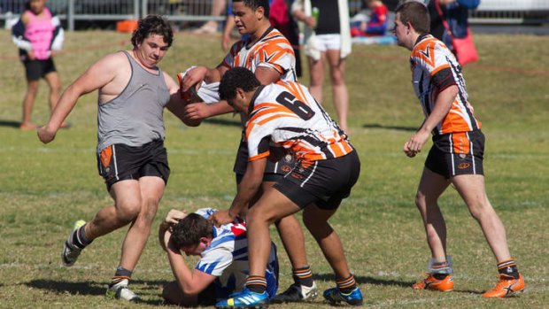 Vicious brawl: Players and spectators fight during the under-19's rugby at Turnbull Oval, North Richmond last weekend.