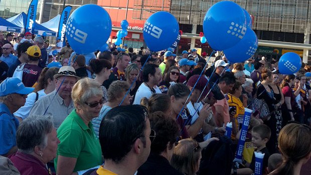 A crowd waits at Suncorp Stadium this morning for the unveiling of the Darren Lockyer statue.
