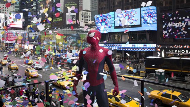 Spider-man stands amidst falling confetti on the Hard Rock Cafe marquee during the annual confetti test ahead of New Year's Eve in Times Square.