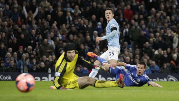 Goal-bound: Manchester City's Steven Jovetic puts the ball past Chelsea keeper Petr Cech during their FA Cup fifth-round tie at Etihad Stadium.