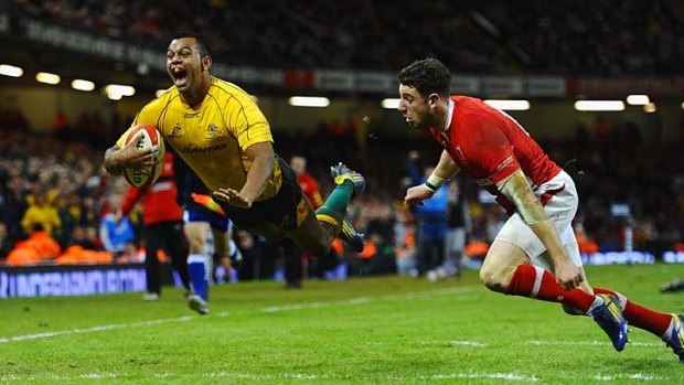 Flying Wallaby: Australia's Kurtley Beale launches himself over the try line to break Welsh hearts.