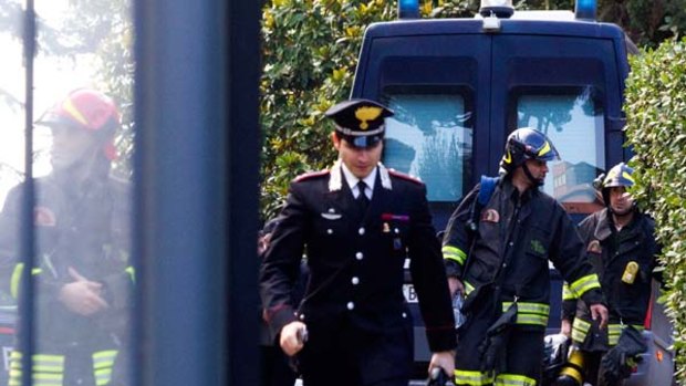 Police officers and firefighters inspect the Swiss embassy in Rome