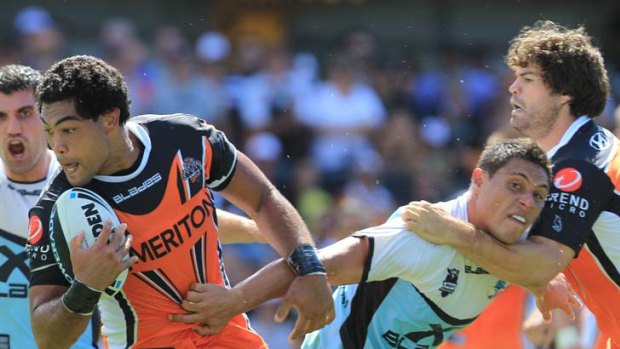 Earning his stripes &#8230; West Tigers's Adam Blair steals the ball away from the Sharks' Anthony Tupou. Wests Tigers won thanks to a golden-point field goal from Benji Marshall.