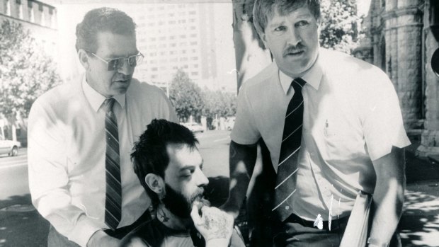 Dennis Bruce Allen, dying of a rare heart disease, is wheeled into court by homicide squad detectives after being charged with murder in August 1984. He died less than five weeks later in hospital. 