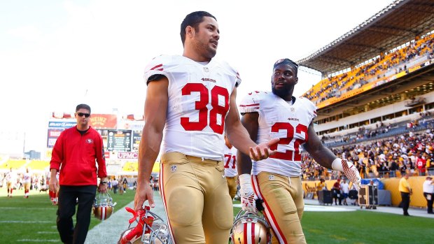 Fitting in: Hayne and Mike Davis leave the field after the 49ers loss to the Steelers.