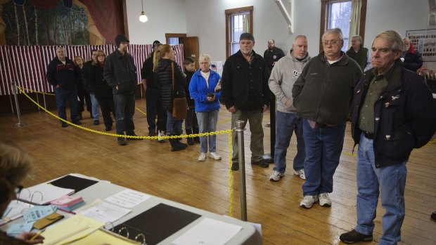 Voters wait in line to cast their ballots in the New Hampshire presidential primary.