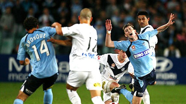 Sydney FC's Sebastian Ryall reacts theatrically to a tackle by a Melbourne Victory opponent during last night's grand final rematch.