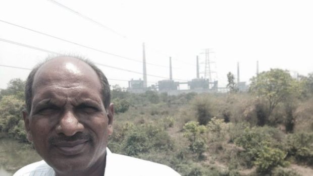 Suresh Chopne, founder of Green Planet, in front of a coal fired power station built on the edge of Chandrapur.