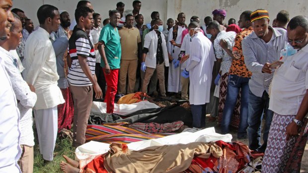 Somalis observe bodies that were brought to and displayed in the capital Mogadishu, Somalia on August. 25.