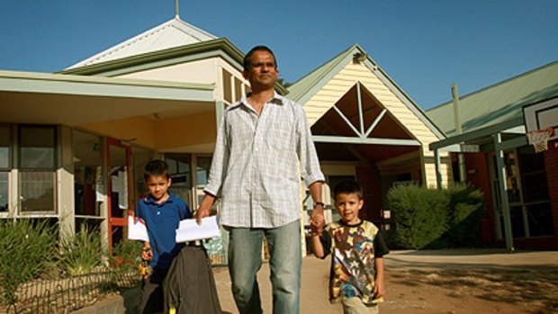 Ramesh Singaram collects sons Sachin, 4, and Rohan, 5, from childcare in Daylesford yesterday.