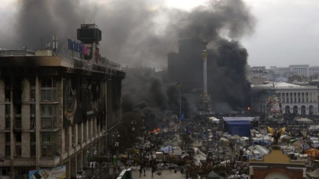 Smoke from burning barricades rise above Independence Square on Thursday.