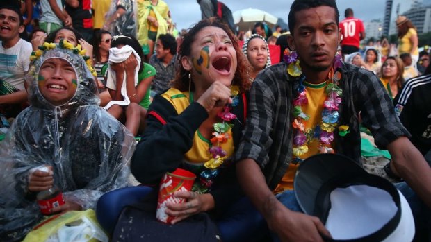 Devastated: Brazilian fans react on Rio's Copacabana beach.