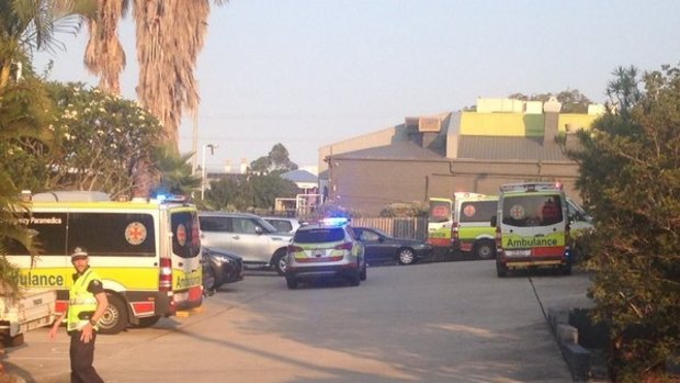 Police investigate a carpark in Booval where a woman was crushed to death by a car.