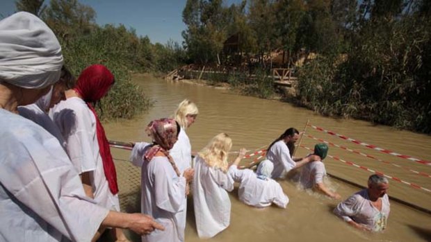 Unholy brew … Orthodox Christians wait to be baptised.