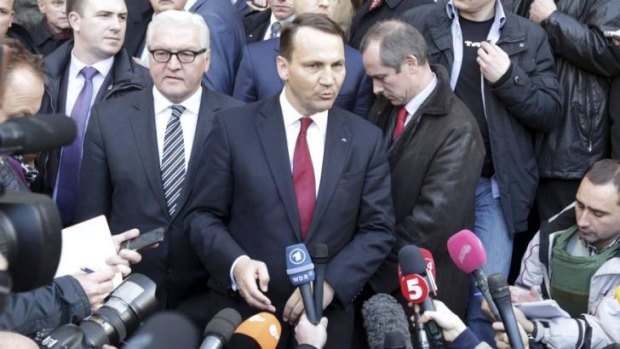 Unlikely partners: Poland's Foreign Minister Radoslaw Sikorski (R) and German counterpart Frank-Walter Steinmeier talk to media after brokering a peace deal in Ukraine.