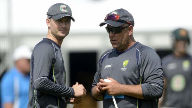Improved atmosphere: Australia's captain Michael Clarke  talks to coach Darren Lehmann during training.