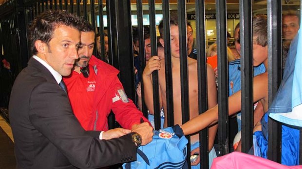 Star man ... Del Piero signs a fan's shirt after the game.