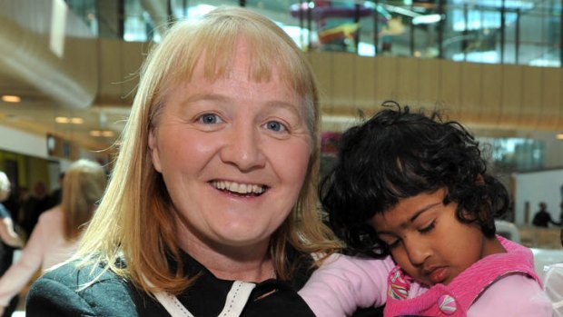 Moira Kelly with Krishna, who was conjoined to her twin Trishna before life-saving surgery.