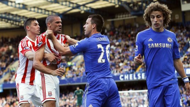 Gripping: Stoke's Jonathan Walters is held back after a crude tackle by David Luiz (right).