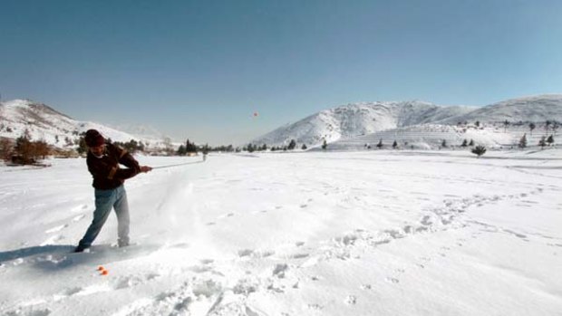 Testing conditions ... a golfer at the snow-covered Kabul Golf Club, which has had stints as a battlefield.
