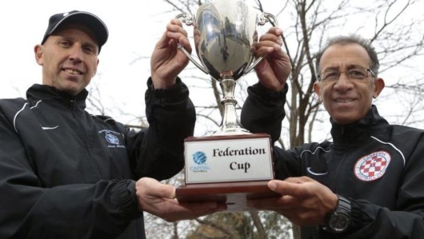 Canberra FC coach Ray Junna, right, was all smiles as he posed with the Federation Cup with Belconnen United coach Dean Ugrinic last week. But two losses later and Junna was sacked on Monday. 
